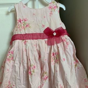 Pink floral toddler dress with matron sash around waist